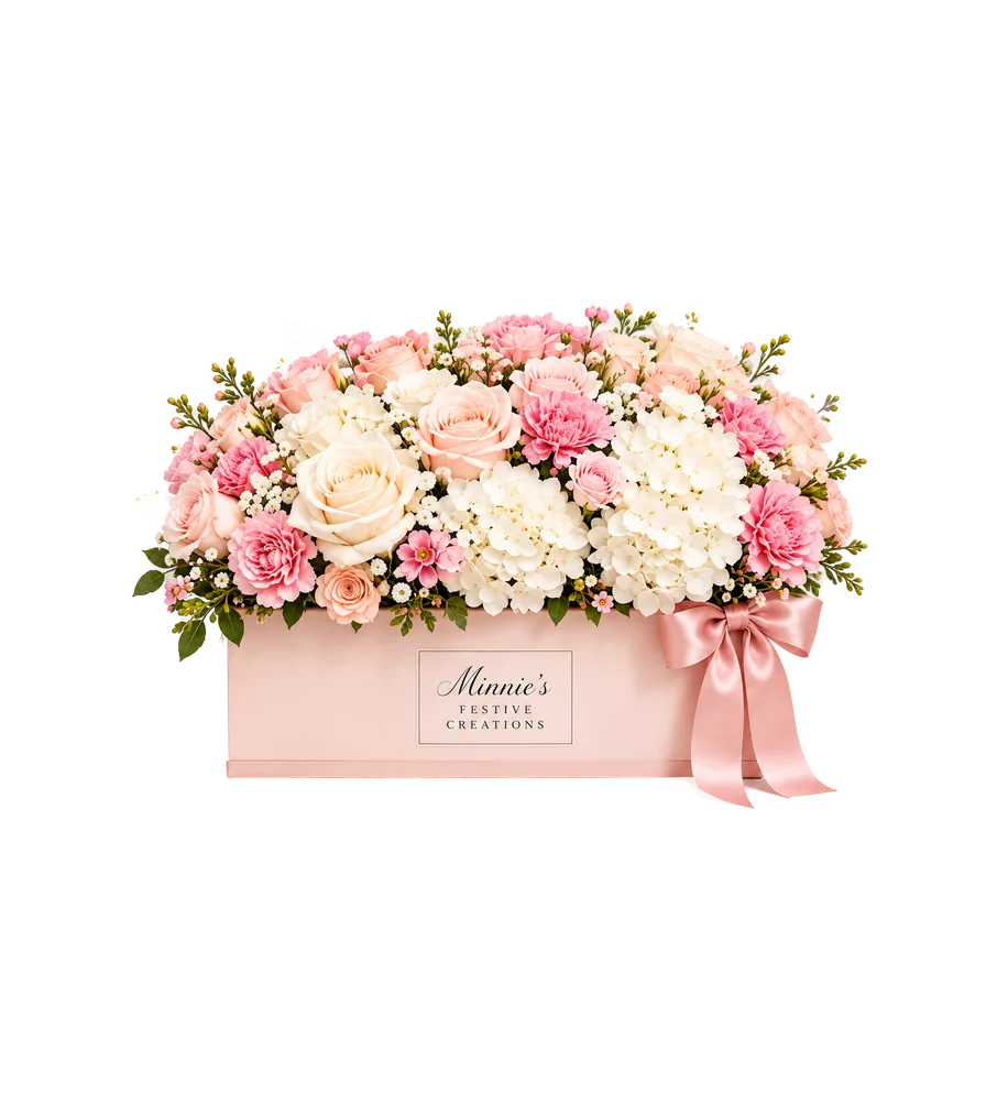 Luxe arrangement of cream and pink roses, carnations and hydrangea in a long blush box